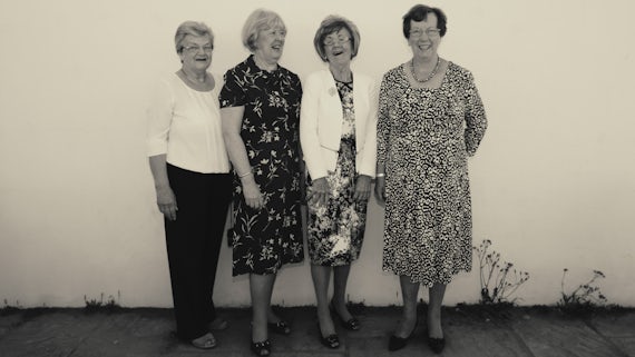 Four Women's Institute members laughing