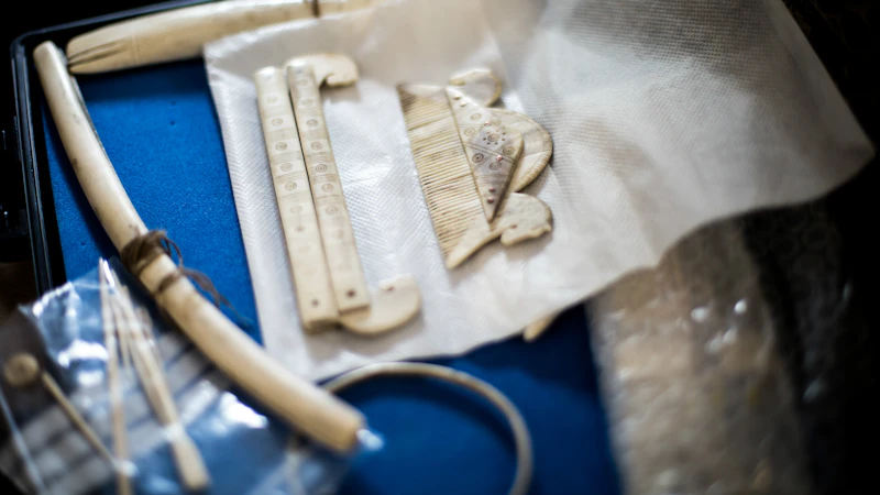 Carved antler comb on a blue tray