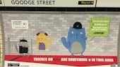 Image of a cartoon cat warning people about crime, on the wall of Goodge Street underground station. 