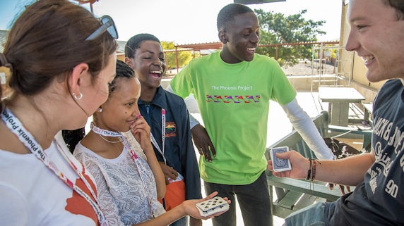 Namibian students laughing at a card trick
