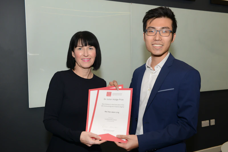 Man and woman hold certificates