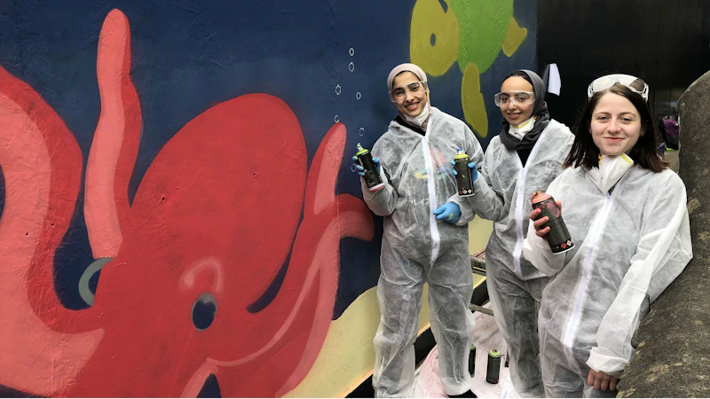 Nursery mural students next to octopus