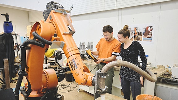 Students using a robot arm