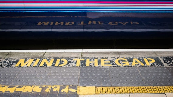 Mind the gap train station sign