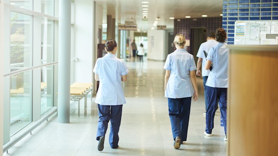 Nurses walking down corridor stock image