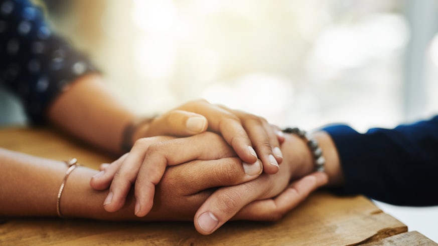 Stock image of people holding hands