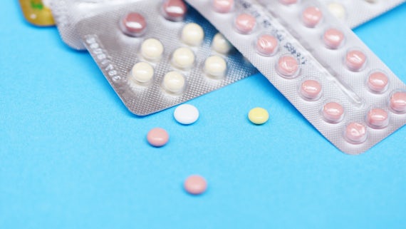 Birth control pills on a blue background.