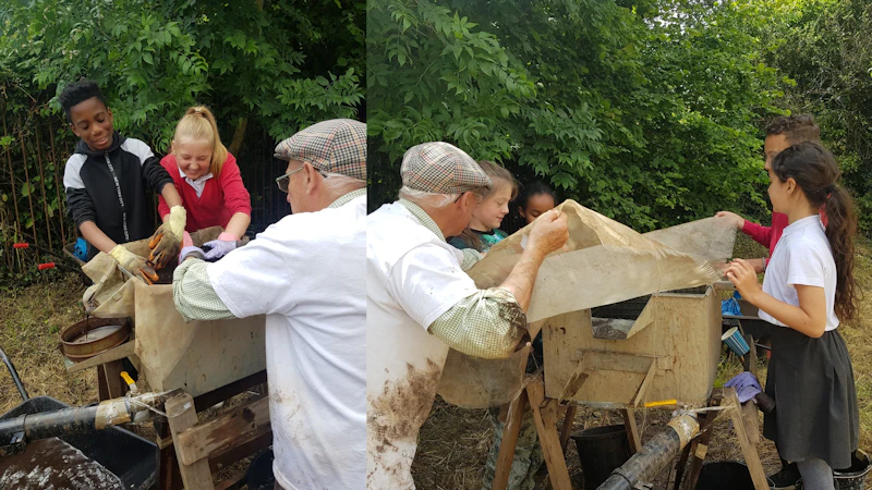 An adult and a group of children sifting muddy objects.