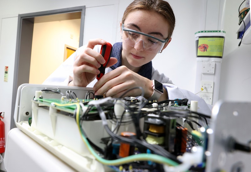 A Medicentre staff member works on a machine