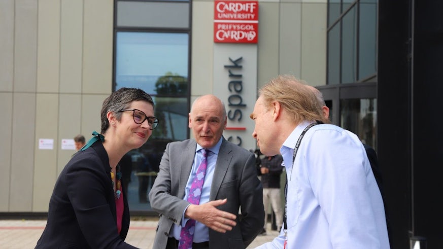 Professor Peter Smowton, Institute for Compound Semiconductors, stands outside the sbarc|spark building at Cardiff University to welcome Minister Chloe Smith MP and Sir Derek Jones for a tour of the Translational Research Hub