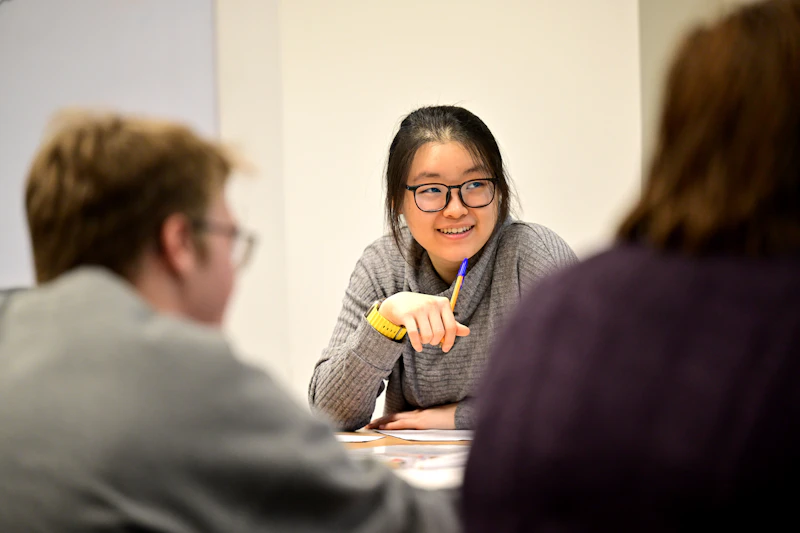 Student in a classroom listening to a talk