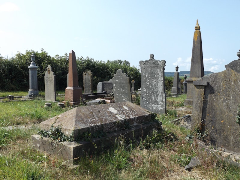 A gravestone in a graveyard.
