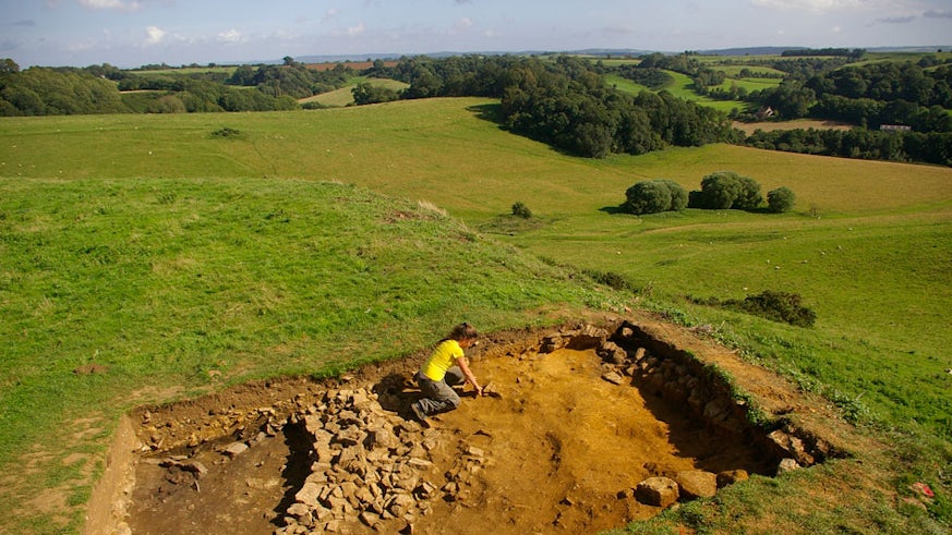 Woman digging in an archaeological trench at Ham Hill