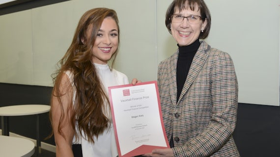 Two women pose with certificate