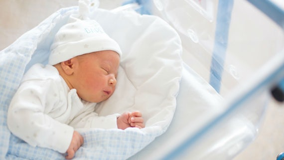 Newborn baby in crib