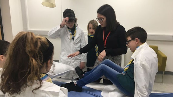 a female researcher shows scouts how to do an mri scan