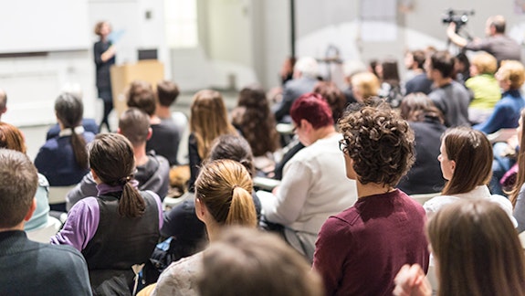 Audience sitting in lecture theatre