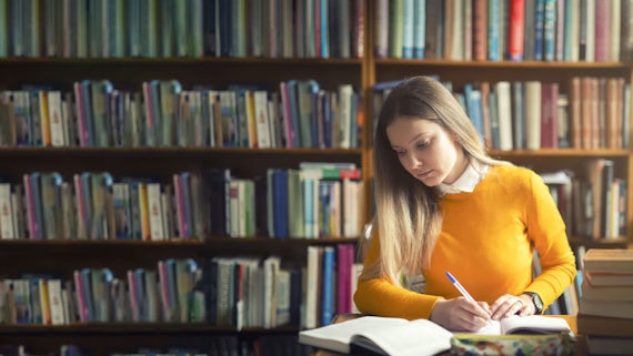 Woman sitting at a table in the library