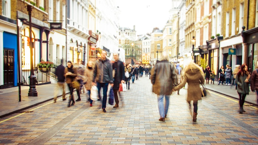 Busy shopping street - stock photo. Motion blurred shoppers on busy high street