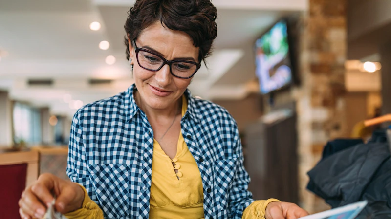 A woman reading a magazine in a cafe