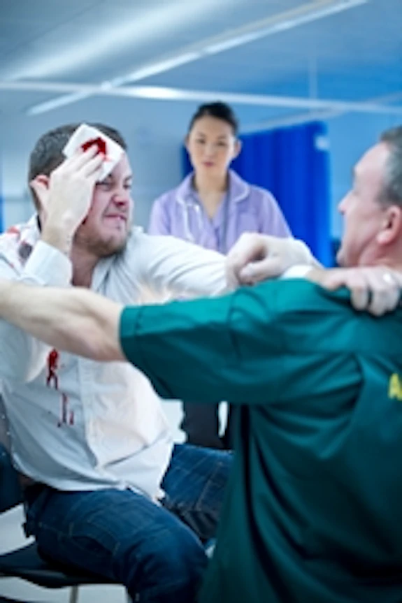 Violent man being restrained by a paramedic