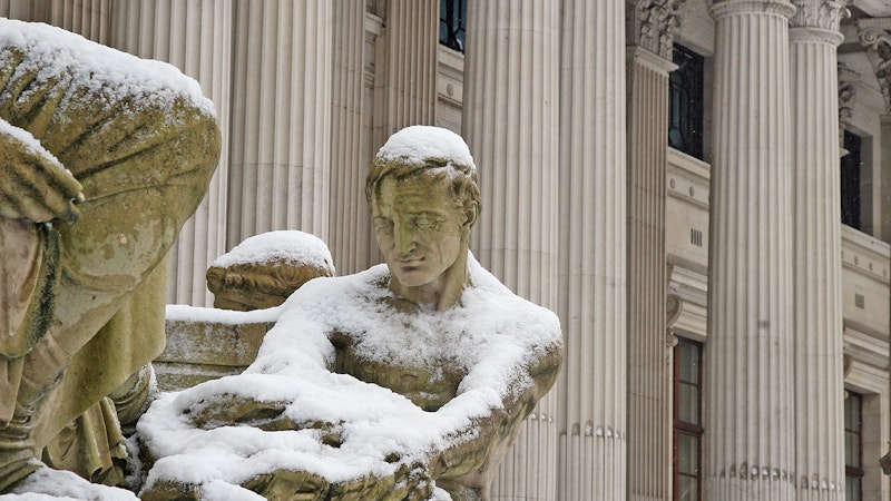 Statue outside a building covered in snow