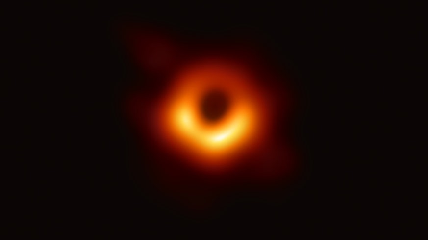 A distorted amber circle mounted on top of a black background. The image is of the M87 black hole