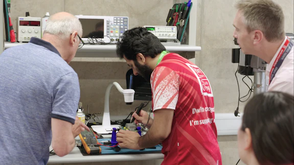 Workshop attendees soldering in the RemakerSpace