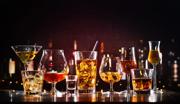 Alcoholic beverages lined up on a bar