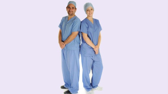 Male and female students modelling uniform for School of Healthcare Sciences
