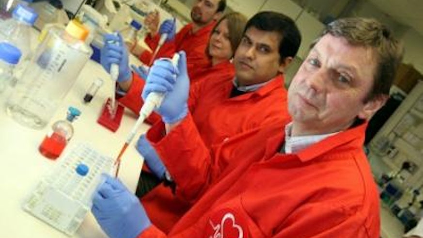University researchers wearing red coats in lab
