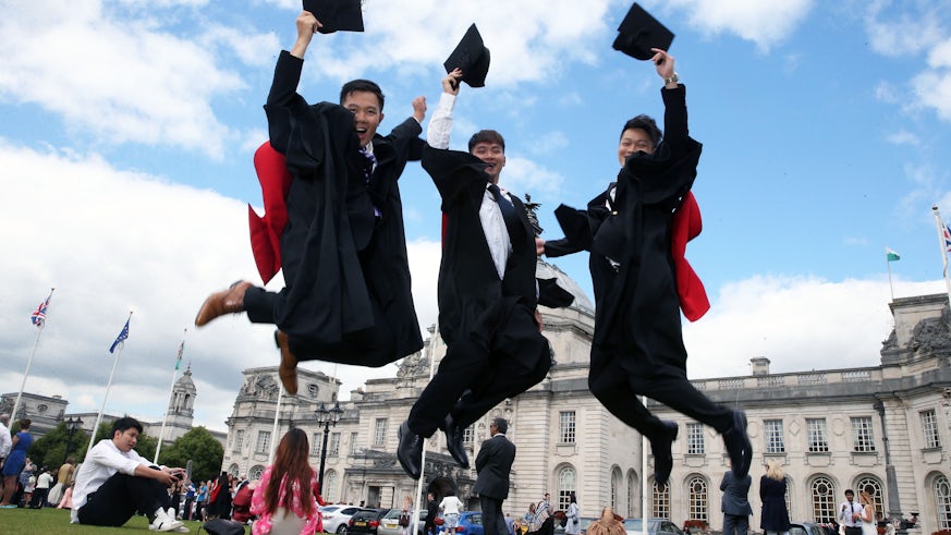 graduates jumping in celebration