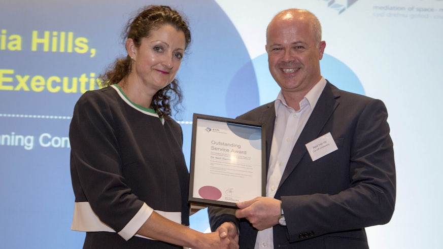 Image of Dr Neil Harris receiving a certificate from RTPI Chief Executive, Victoria Hills
