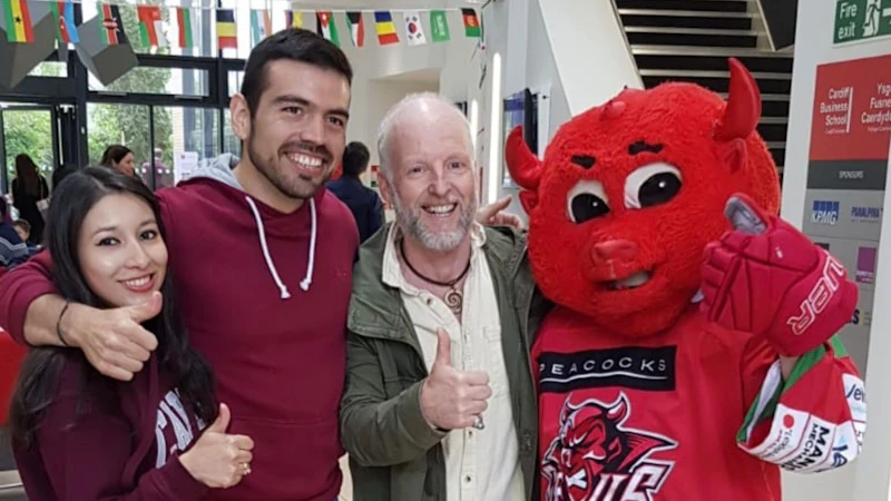 People posing with mascot