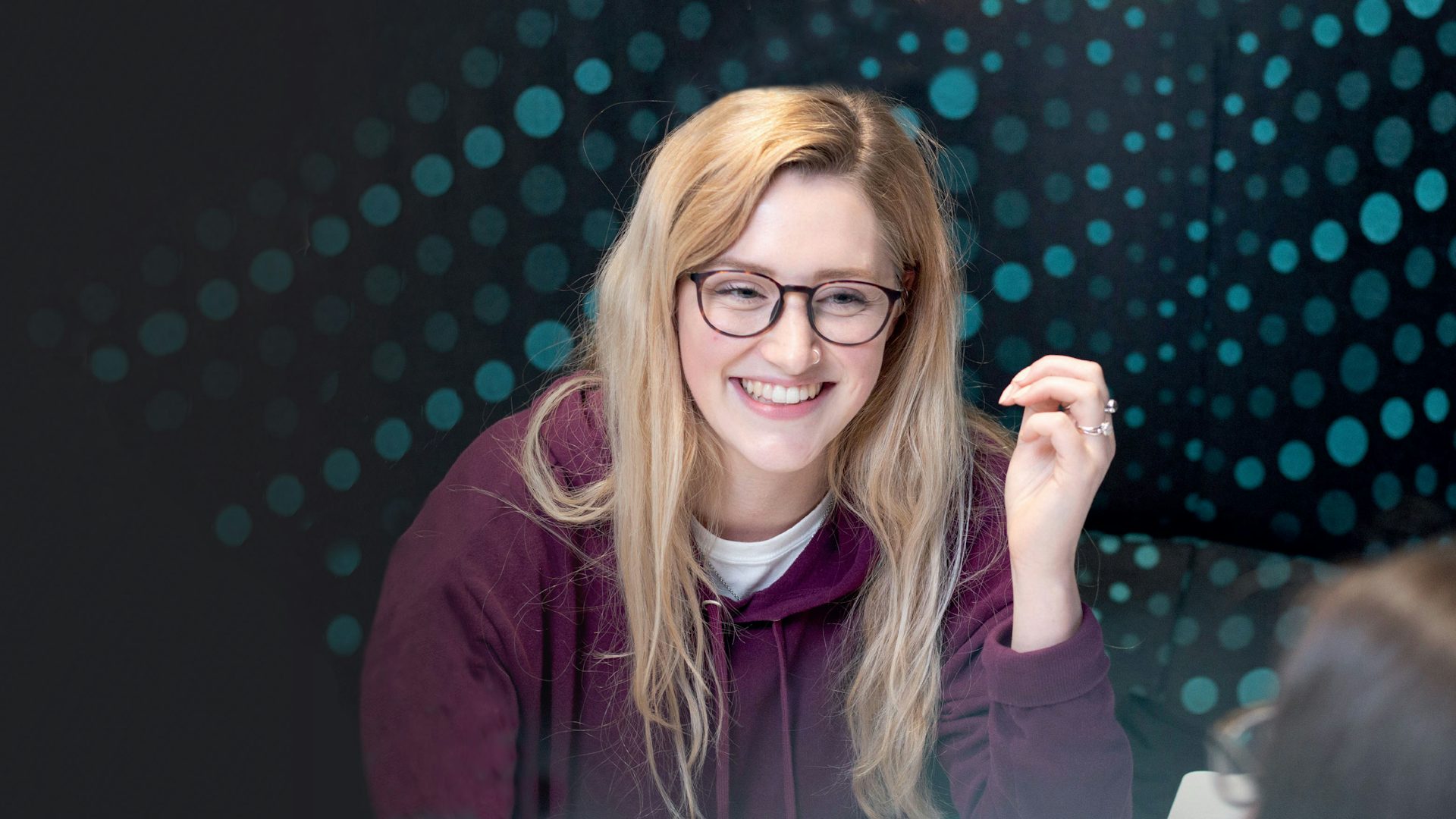 Student talking with patterned background