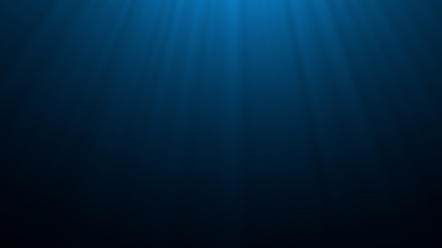 Dark underwater scene beneath blue sun beam