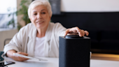 Older woman using a smart speaker