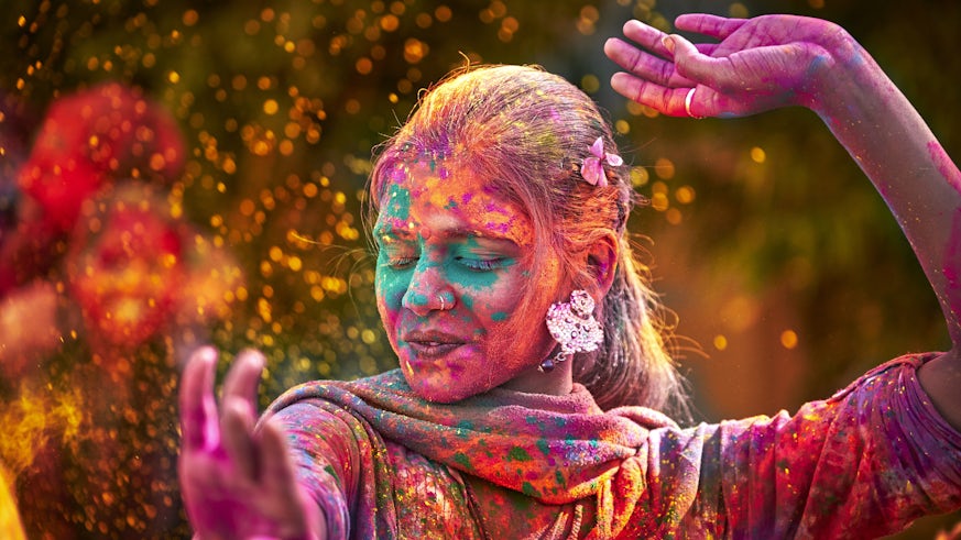An image of a lady celebrating Holi.
