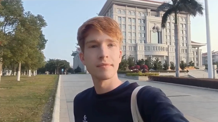 Benjamin Miller (BA Chinese) standing in front of a Xiamen University building