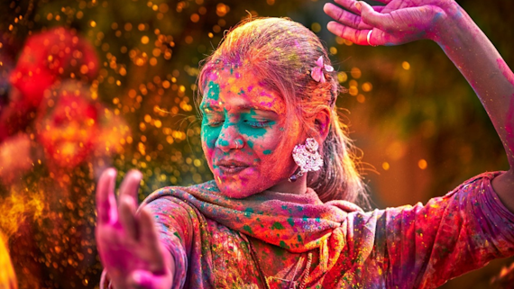 Image of a woman dancing in the Holi Festival of Colours