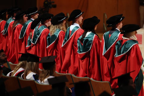 Graduates with red ceremony dress
