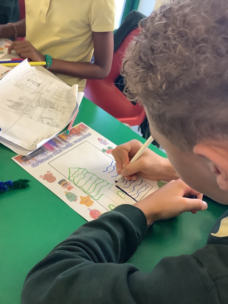 Schoolchildren show designs they have created using pipe cleaners.