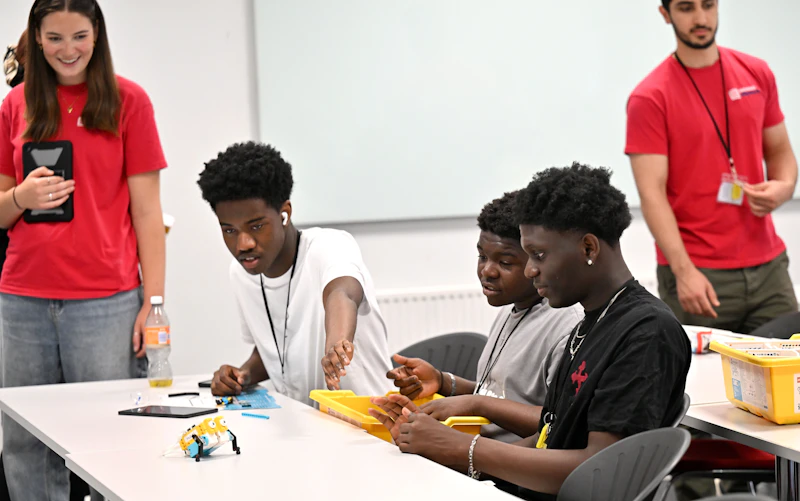 Participants working together on a practical STEM challenge using small construction kits.