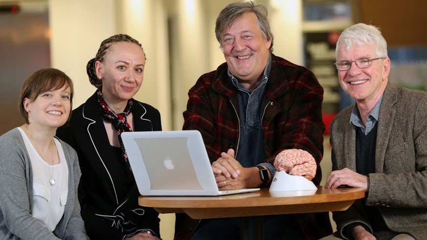 photograph of Stephen Fry with team at Neuroscience and Mental Health Research Institute  