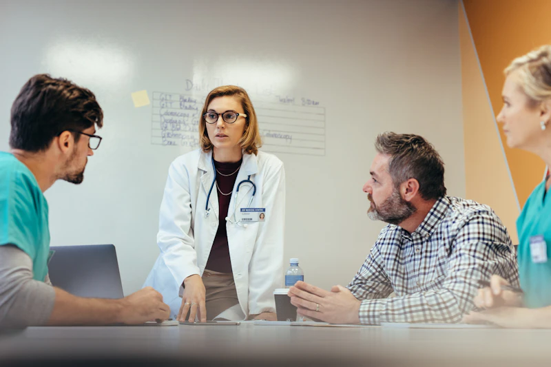Female doctor leading group discussion with peers