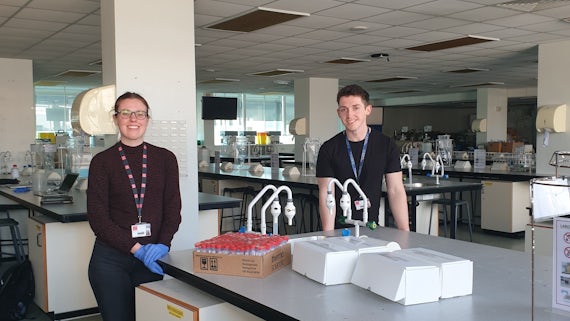 Two volunteers sat in the teaching labs in School of Biosciences