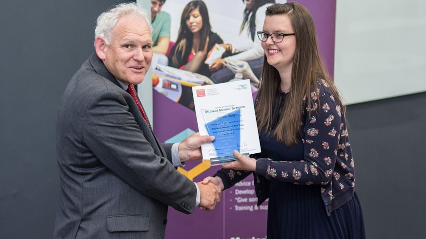 Nicole Riley receiving her trophy at the Student Mentor Celebration event