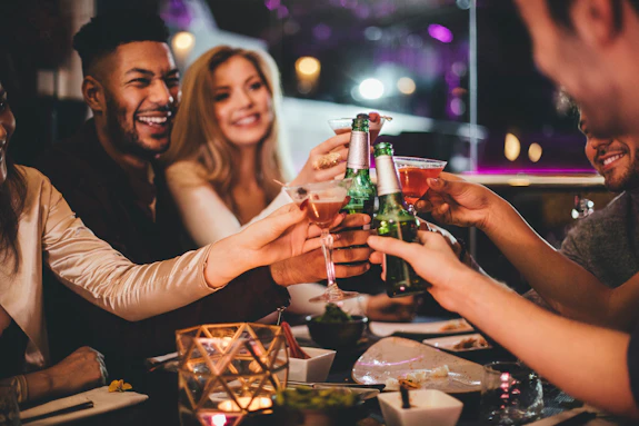 Friends holding drinks in a cheers