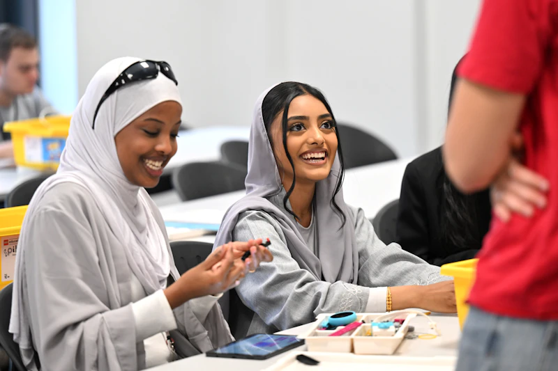 Step Up participants working together on a hands‑on engineering task.