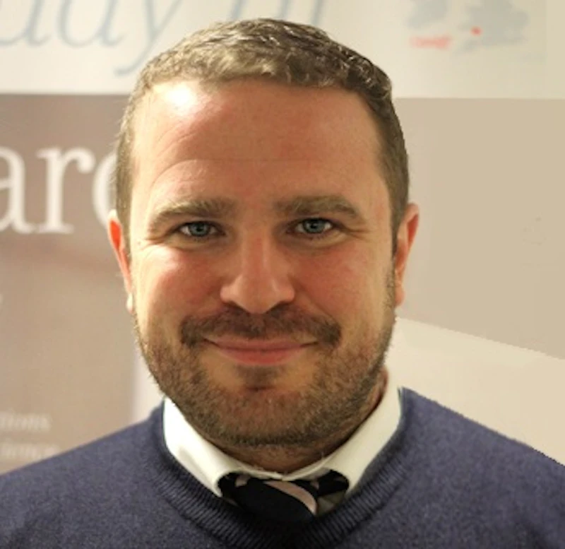 Portrait shot of a man smiling.